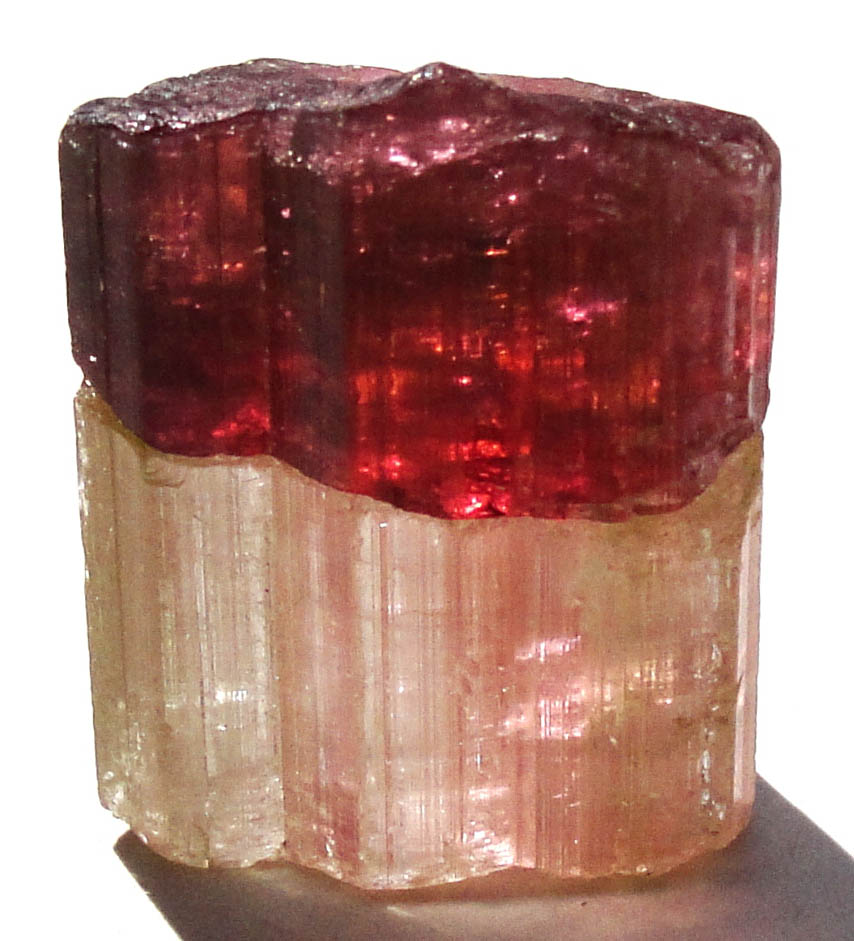 Irradiated Tourmaline Crystal. Half natural color, half irradiated red color.