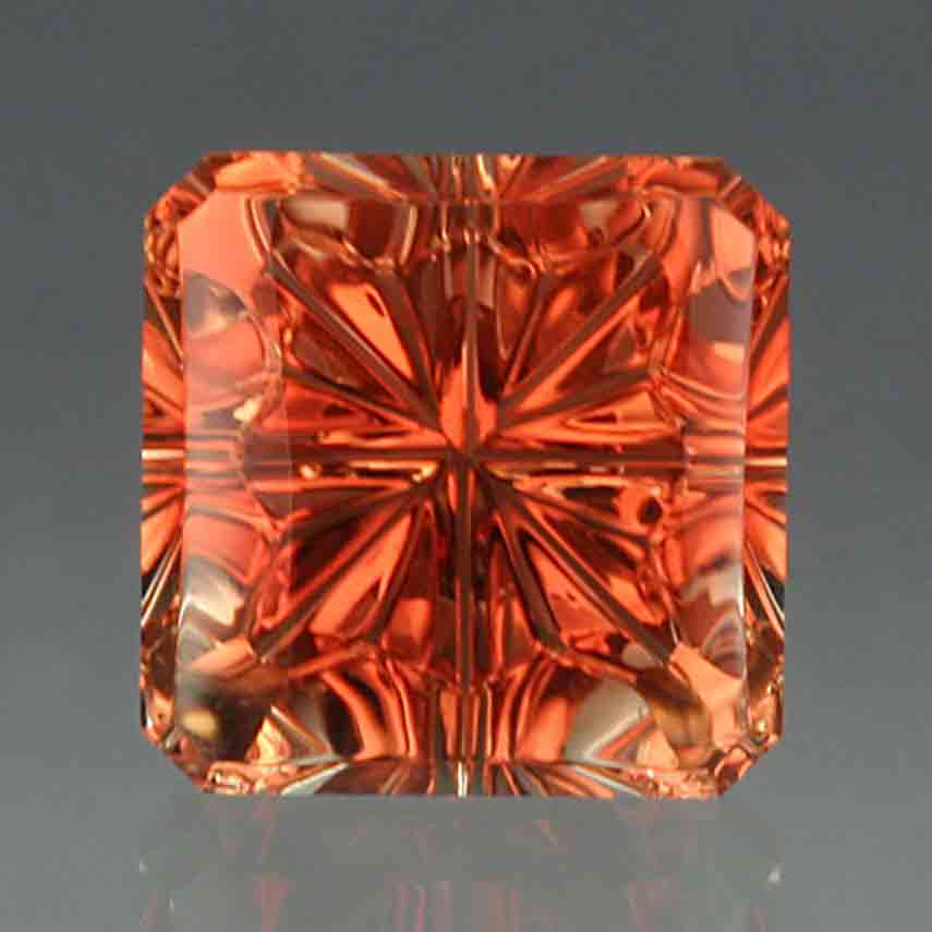 Orange peach color Oregon sunstone StarBrite cut by John Dyer